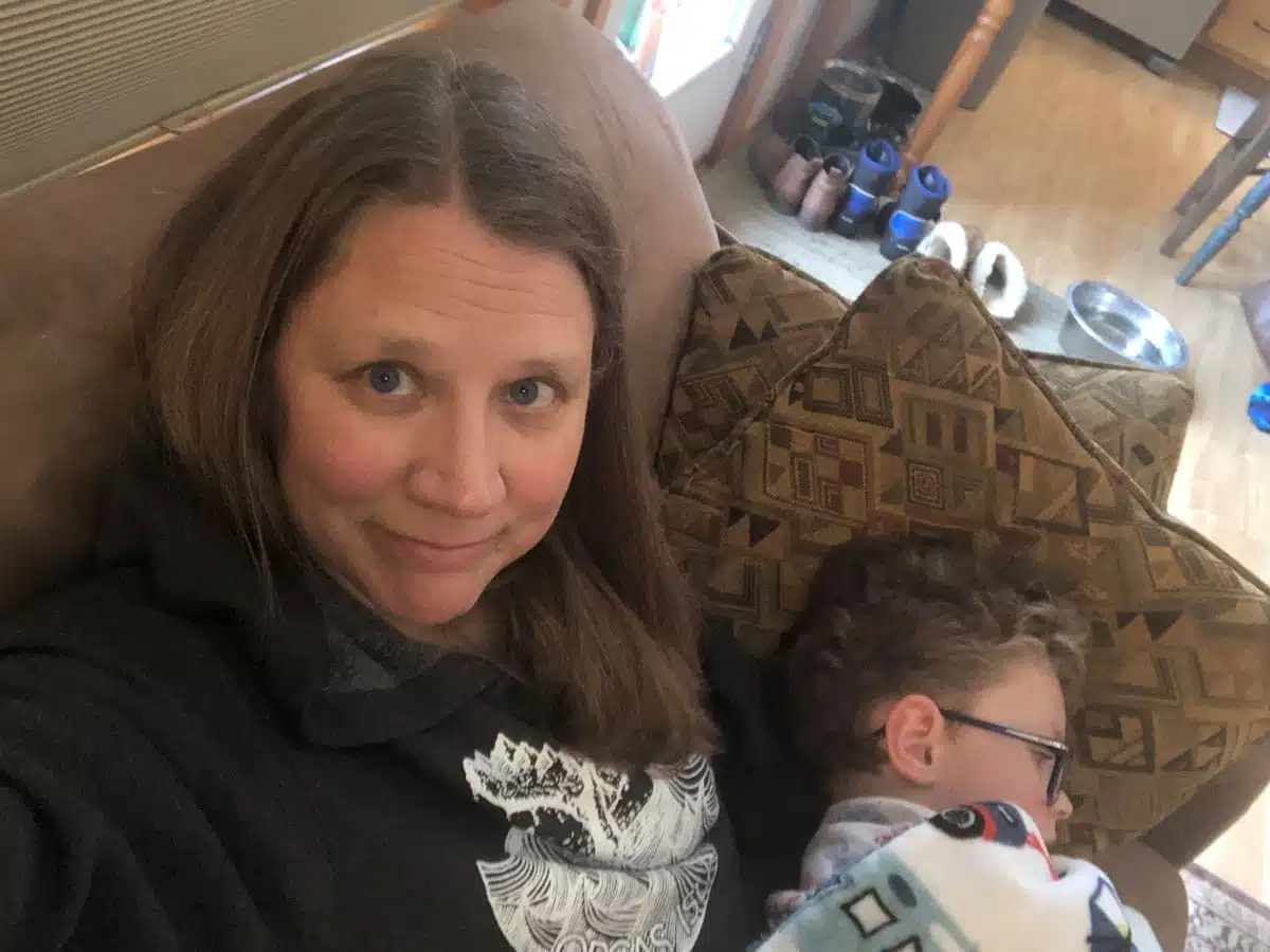 Stacey Couch at home with her son as part of her sharing her story about having the chronic illness, ME/CFS.